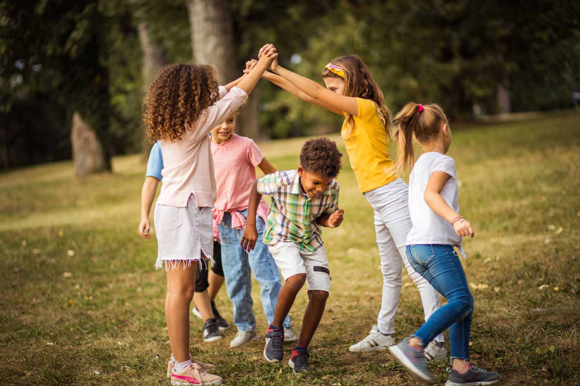 Large group of school kids having fun in nature. Playing time.
